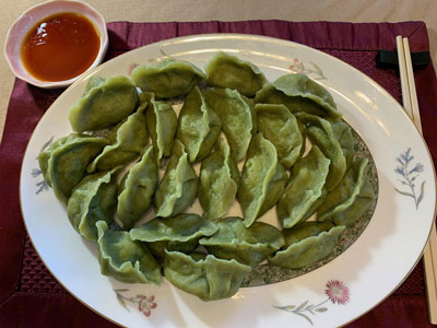 A dinner plate with green algae gyoza made with WPRO30+ algae protein powder